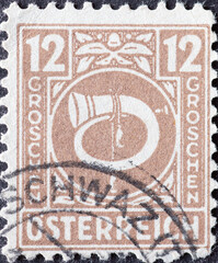 Austria - circa 1945: a postage stamp from Austria, showing a post horn 12 Groschen