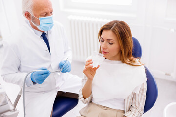 Patient washing up oral cavity at dentist office
