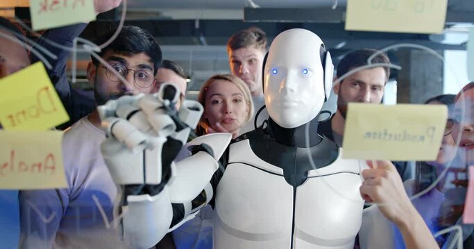Team of startup planning future tasks in office with humanoid. People and artificial intelligence discussing work and project. Brainstorming meeting. Management strategy. Digital transformation