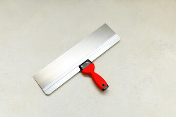Clean trowel on concrete floor, close up. Construction finishing works
