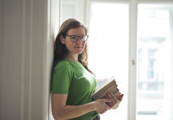 portrait of young woman with books in hand