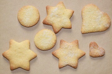 Baked cookies of various shapes and sizes sprinkled with sugar.