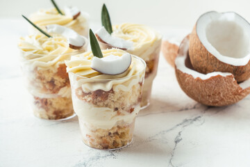 English layered dessert trifle of buscuit dough, custard and whipped cream with fresh coconut...