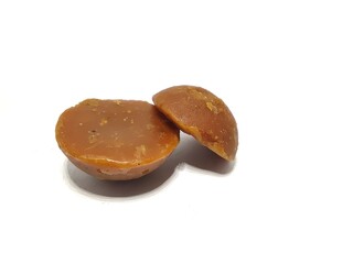 Organic palm sugar or Jaggery from India. Brown sugar isolated on white background