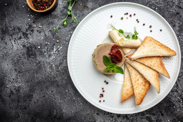 Delicious chicken liver pate with butter and sun-dried tomatoes and bread on plate. Healthy food trend