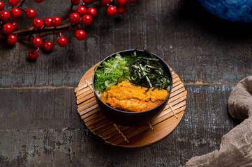 Sea Urchin Chawanmushi in a dish with chopsticks isolated on mat side view on wooden table taiwan food