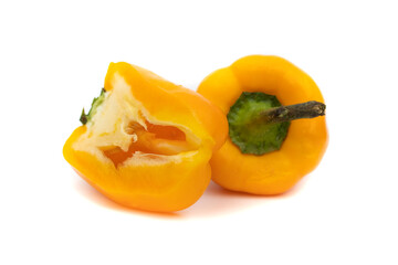Naklejka na ściany i meble One whole yellow pepper and one cut in half. Isolated on white background. Capsicum baccatum is a species of the Solanaceae genus Capsicum.