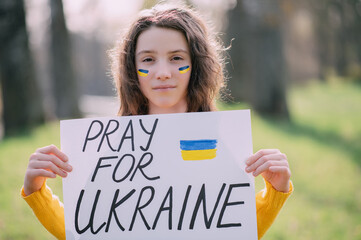 Close-up Ukrainian girl asks to pray for Ukraine. Concept is no war in Ukraine.