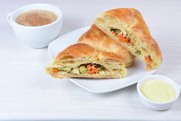 Puff pastry cake with vegetables and cheese, on wooden background