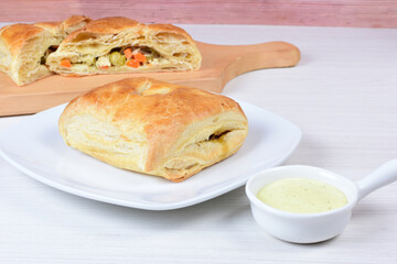 Puff pastry cake with vegetables and cheese, on wooden background