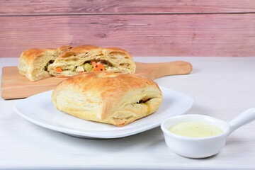 Puff pastry cake with vegetables and cheese, on wooden background
