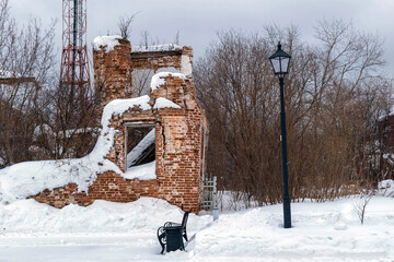 a dilapidated stone house in the snow
