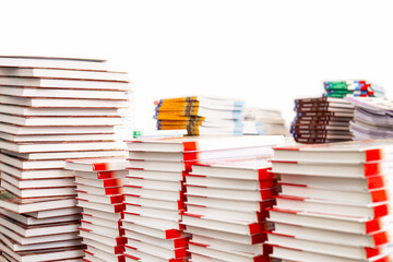 Stacks of various books, isolated on a white background.