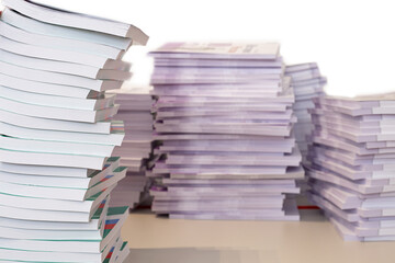 Stacks of books on the table, isolated on a white background.