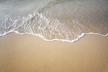 Fototapeta na wymiar Sand and sea wave. Beach copy space nature background.