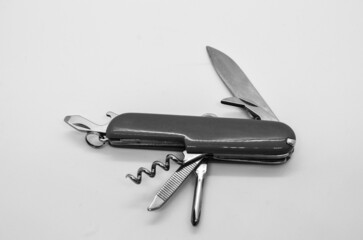 Isolated black and white switzerland knife, multi tool opened swiss army knife with wine opener in...