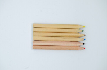 Isolated top view colorful wooden drawing pencils on white background