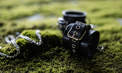 leather handcuffs for bdsm sex toys on green grass