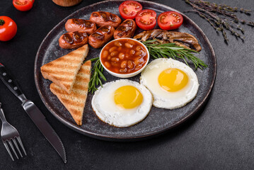 Full english breakfast with bean, fried eggs, roasted sausages, tomatoes and mushrooms