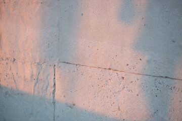 a concrete wall illuminated by the setting sun