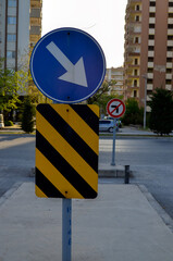 multiple traffic signs in Turkey, one way direction, refuge top additional board, forbidden to turn...