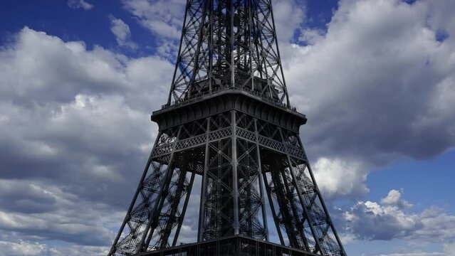 Eiffel Tower in Paris, France (against the background of moving clouds, time lapse, with zoom) 