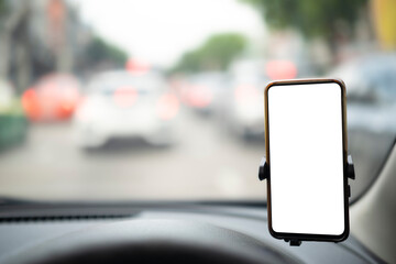 Modern smartphone device gadget mounted on phone holder at car dashboard. Mock-up white screen...