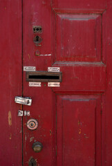 Old Red wooden door with mailbox. Wood texture. The Red tree. Closed door.