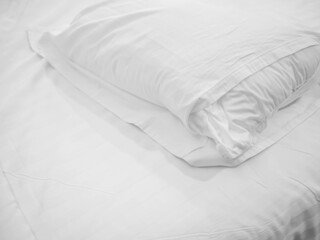 Closeup of wrinkle pillow, pillowcase and bed for room service, housekeeping, homework preparing or allergy protection concept