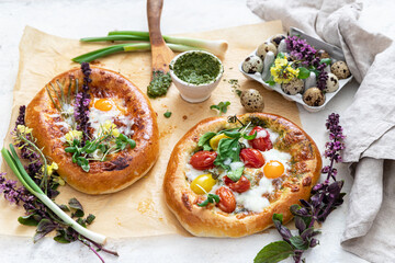Flatbread pizza with pesto , herbs, eggs and mozzarella	