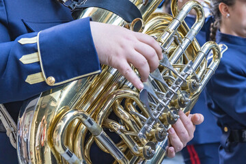 Detail of a tuba being played by a musician in a Holy Week procession