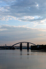 Peaceful sunrise in the sunny morning on the Dnipro river, Kyiv Harbour city, Ukraine. View on the The Podilskyi Bridge