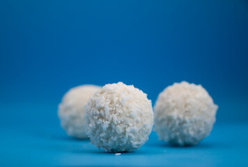coconut candies on colored background