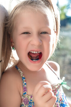 Little girl with crooked teeth and orthodontic appliance.