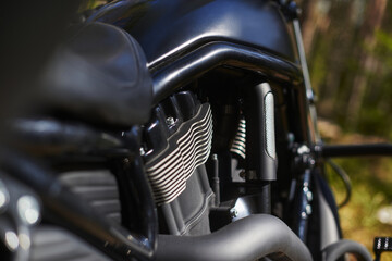 Fototapeta na wymiar black motorcycle engine block with cooling radiators, pipes and gas tank