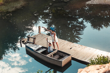 Mom and daughter enjoy the boat on the lake