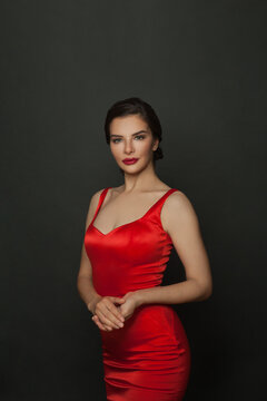 Perfect Stylish Model Woman In Red Dress Looking At Camera