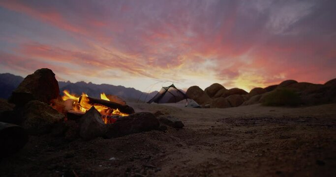 Sunset over campsite with campfire and tent in Alabama Hills, California