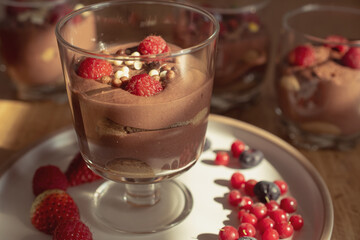 Chocolate mousse with raspberries and strawberries in a glass