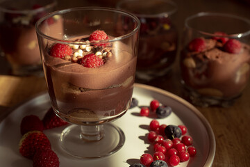 Chocolate mousse with raspberries and strawberries in a glass