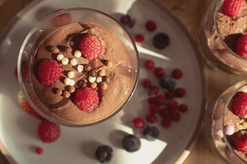 Chocolate mousse with raspberries and strawberries in a glass