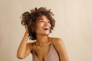 Young positive woman feeling relaxed in studio - obrazy, fototapety, plakaty
