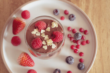 Chocolate mousse with raspberries and strawberries in a glass