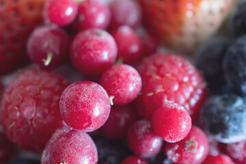macro photo of frozen strawberries, raspberries and currants