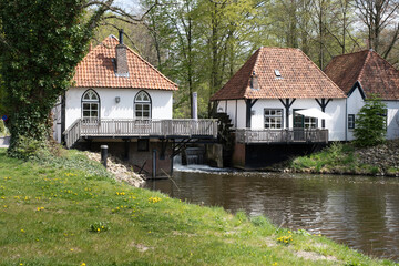 Fototapeta na wymiar The restored historic water mill called 'The Olliemolle' or 'Den Helder' in the stream of the river the Boven-Slinge in Winterswijk in the Netherlands