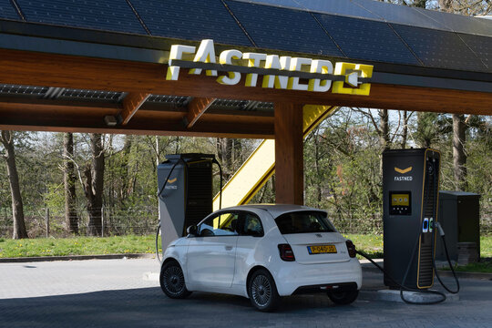 HEERDE, THE NETHERLANDS - APRIL 20, 2022: Electric transport. Charging a Fiat 500E with power at a public charging station in Fastned's fast-growing car charging network in the Netherlands