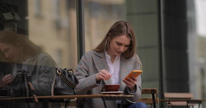 Woman content maker photographing cup of coffee by smartphone