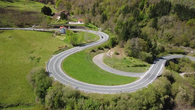Cars driving along the mountain road of the ascent to the Puerto del Escudo, in Cantabria.