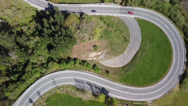 Cars driving along the mountain road of the ascent to the Puerto del Escudo, in Cantabria.