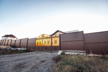 brown fence with metal profile gate